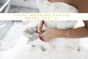 Female in wedding dress holding white shoes with rhinestones