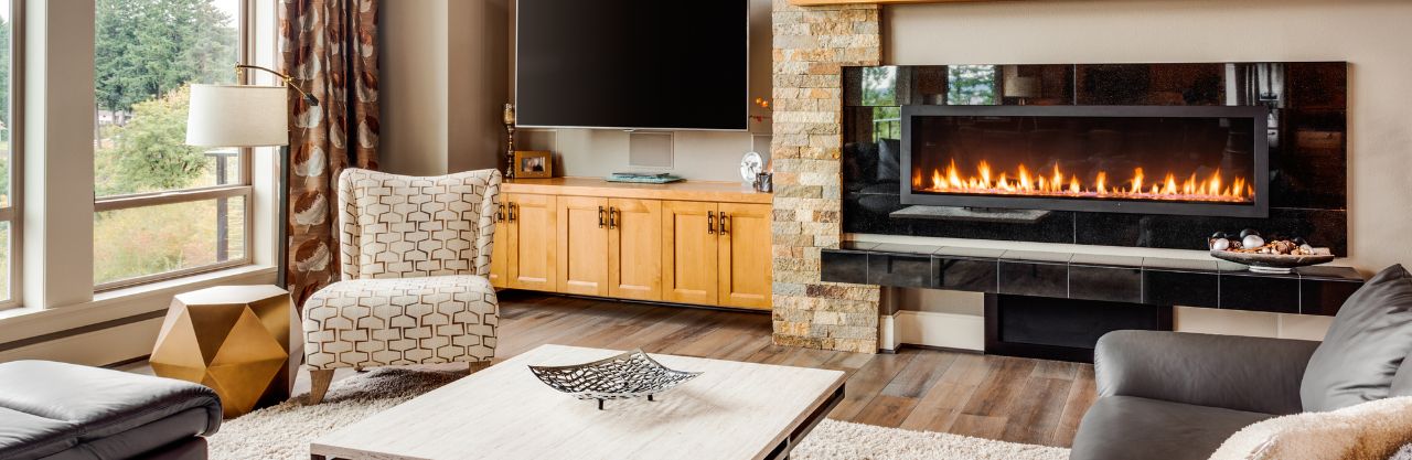 Cozy Livingroom of autumn tones with gas fireplace with flames.