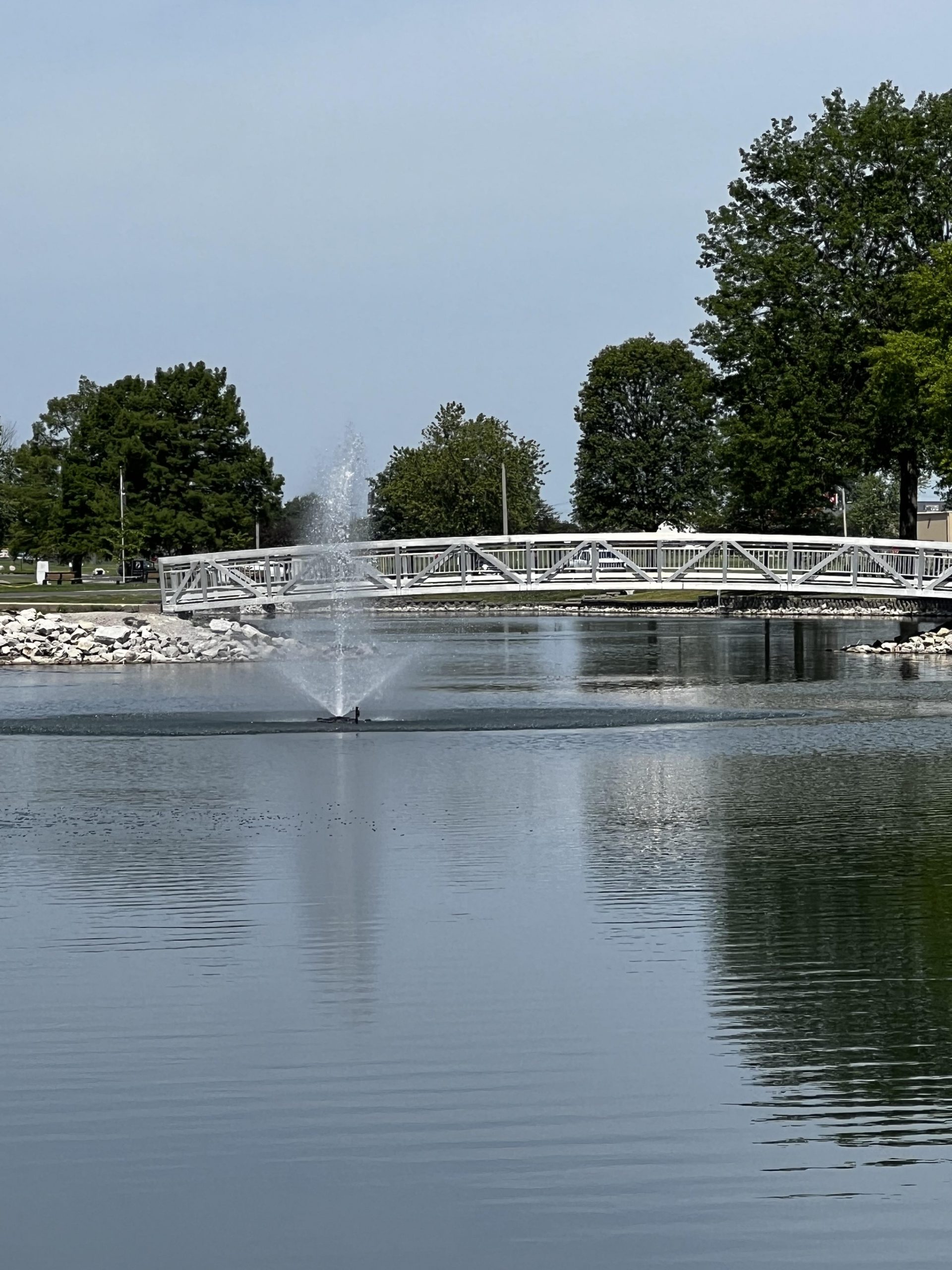 Walk way bridge over water with a fountain