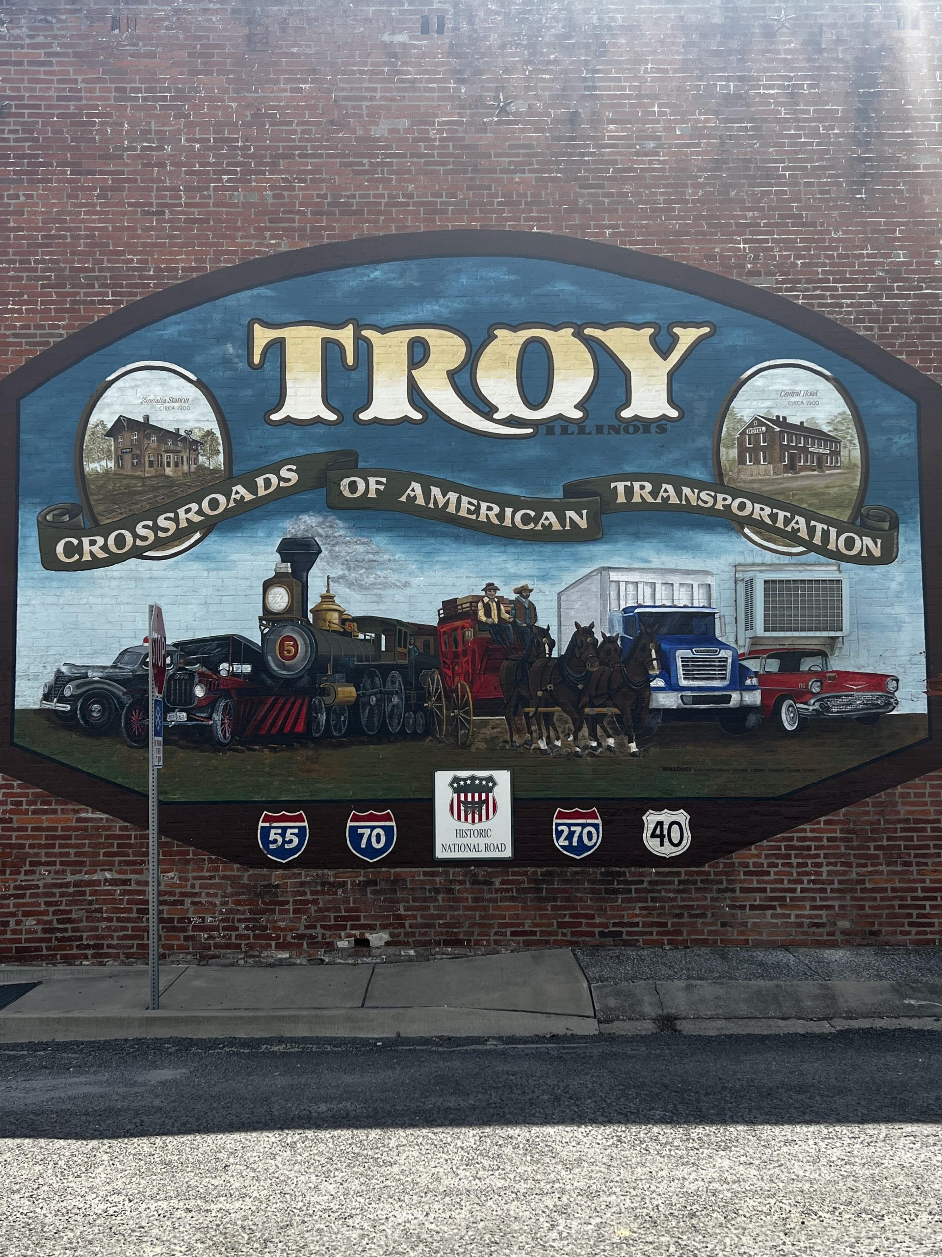 Mural of Troy crossroads of American Transportation, horses, train, truck, car with historic road signs of 55,70, 270 and 40.,