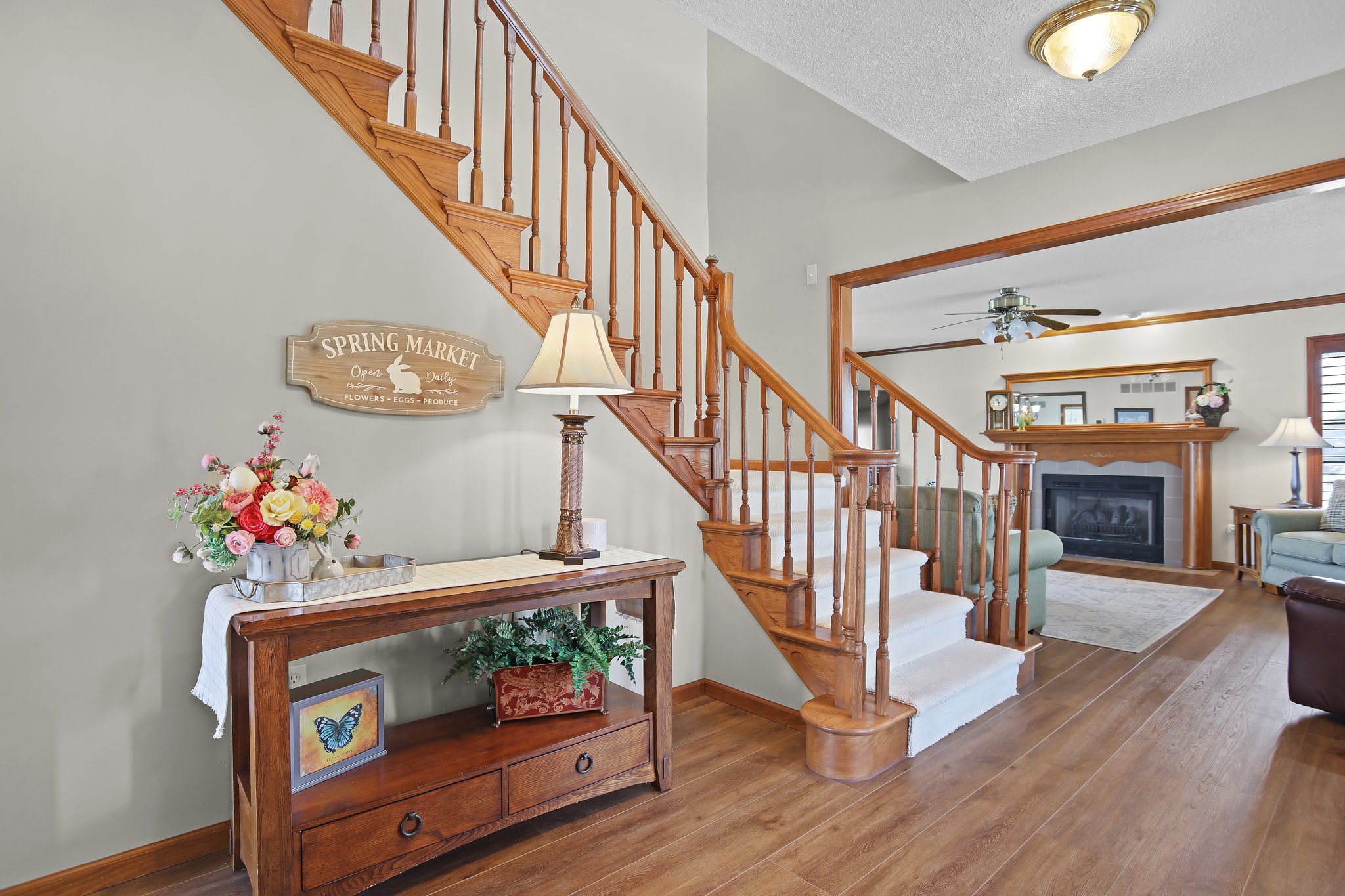Entry foyer, staircase, oakwood railing, carpet and luxury vinyl flooring | wood like