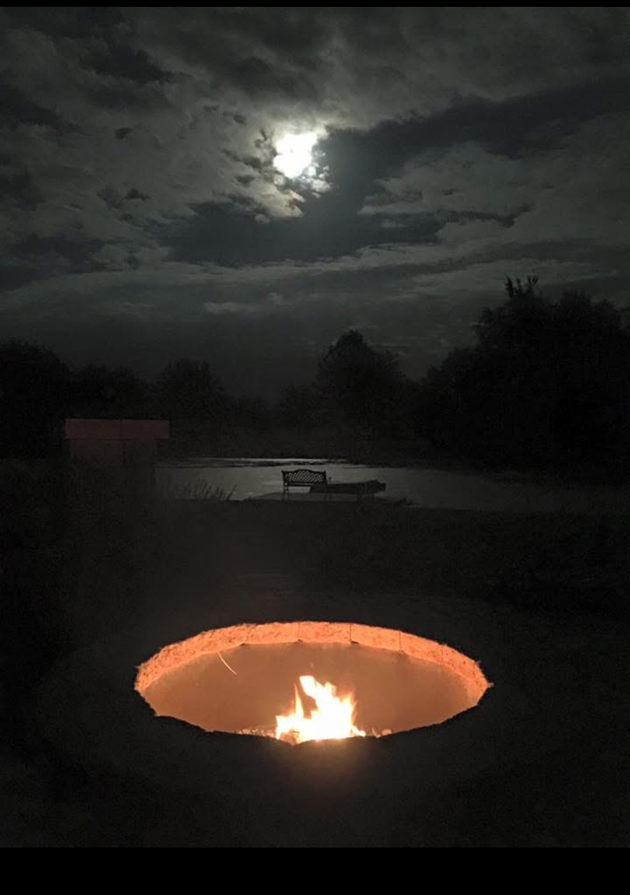 View of Moon Lit Pond over Fire Pit