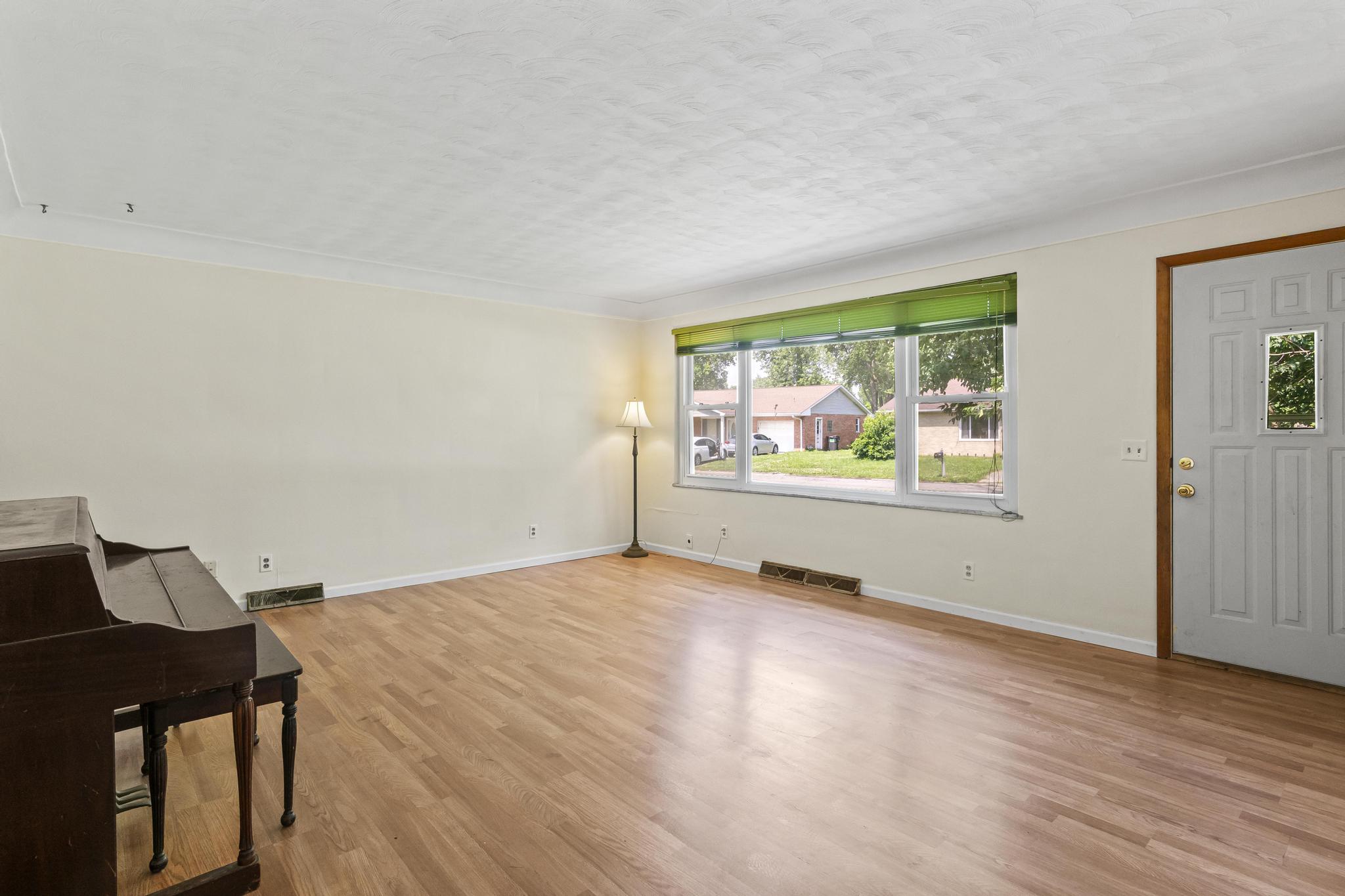 Living room, laminate wood-style wood flooring and large window
