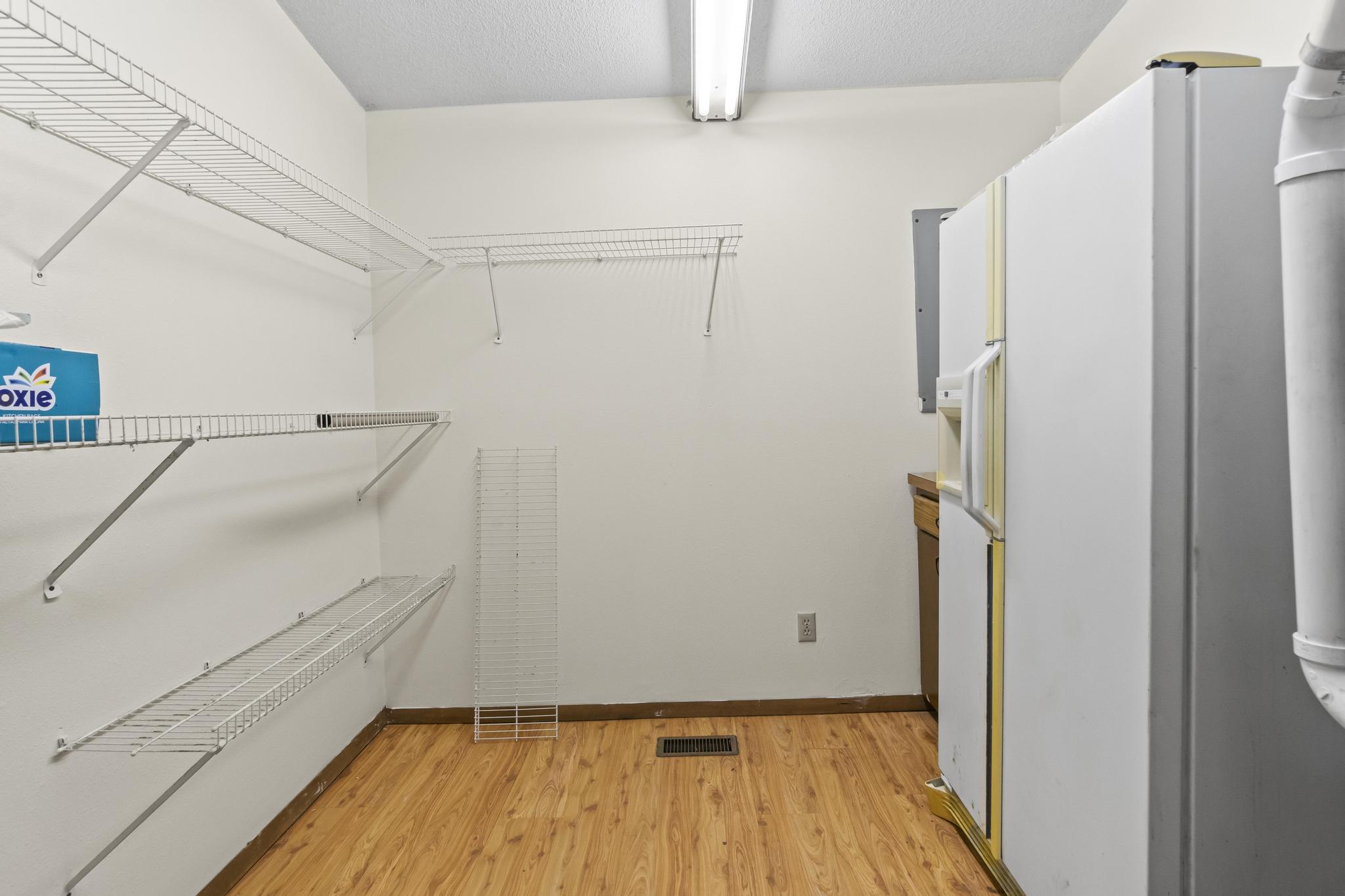 Walk-in Pantry/Utility room, wire shelving, laminate wood-style flooring