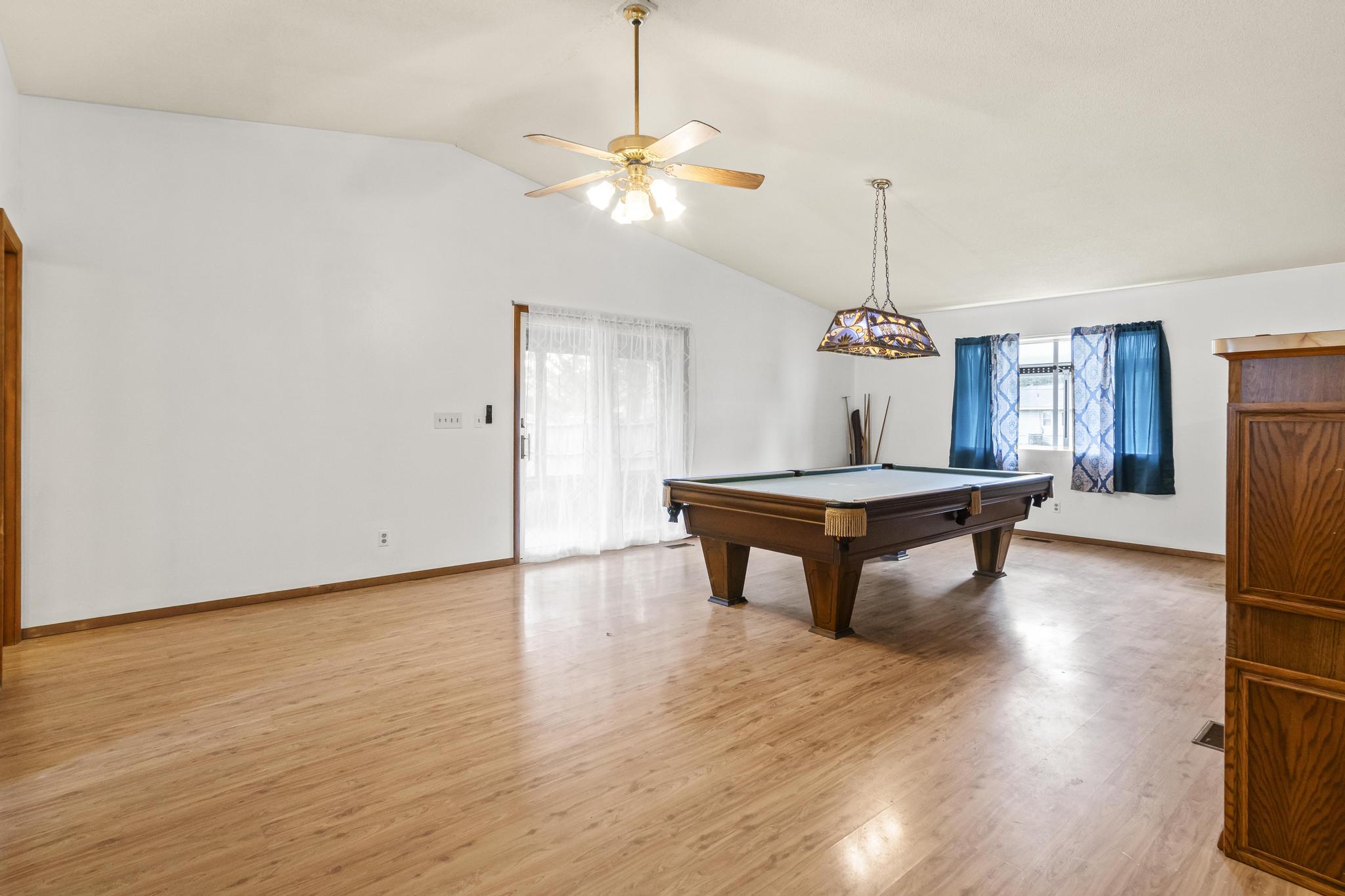 Great room/game area, pool table, laminate wood-style floor