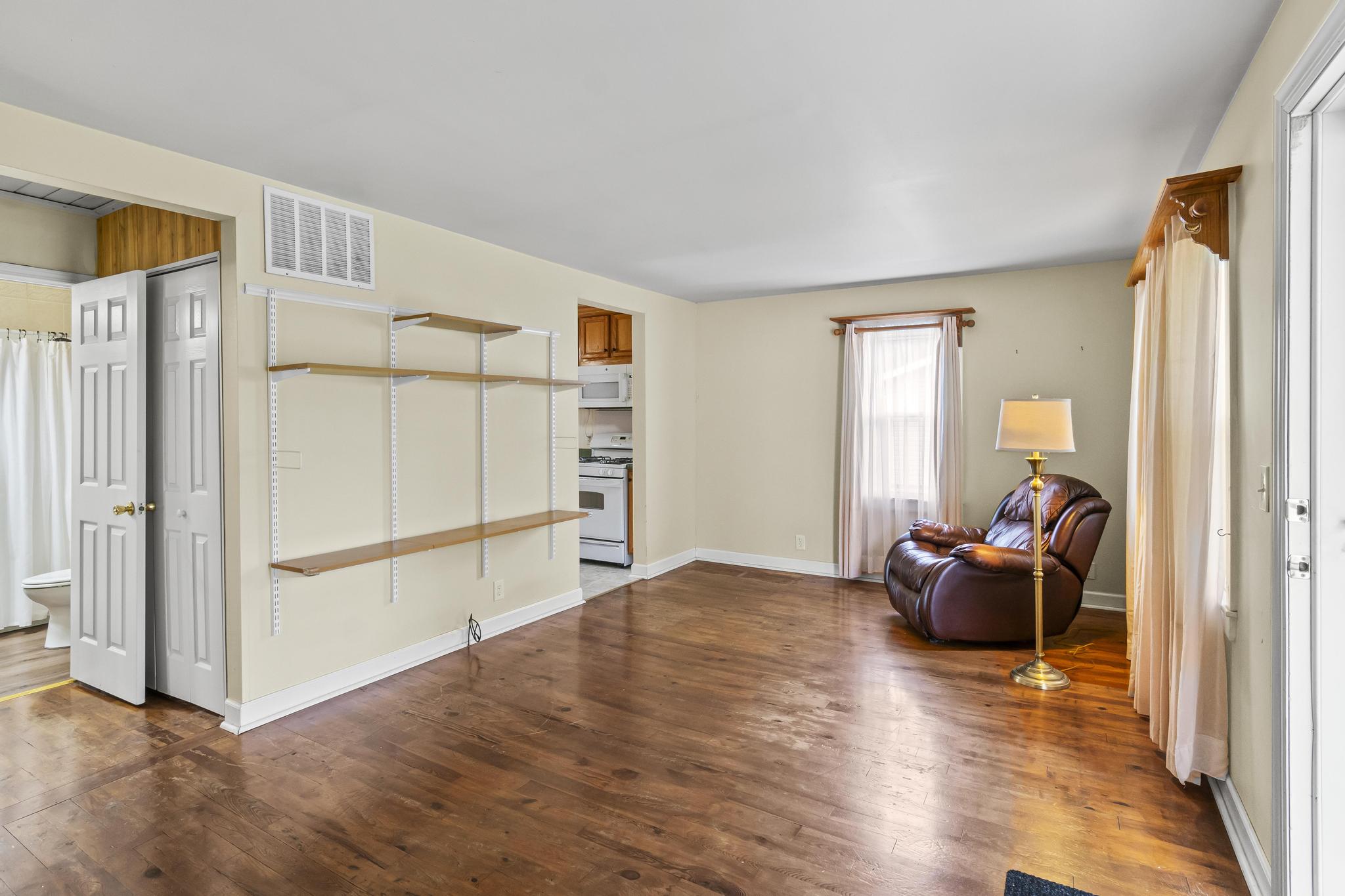 Living room feature wood floors and shelving