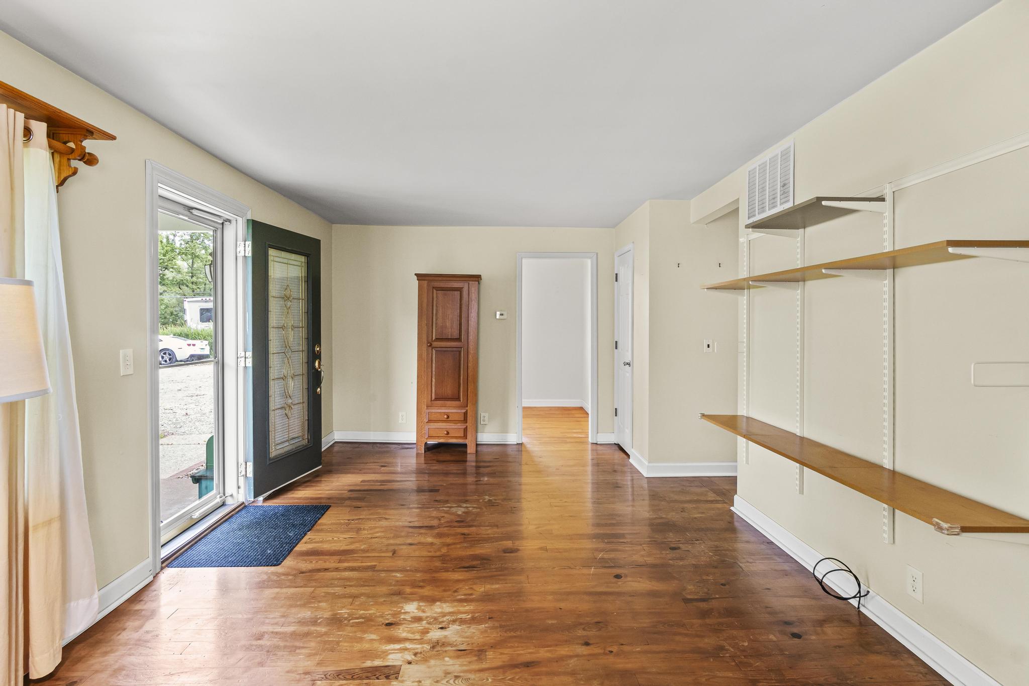 Living room feature wood floors and shelving
