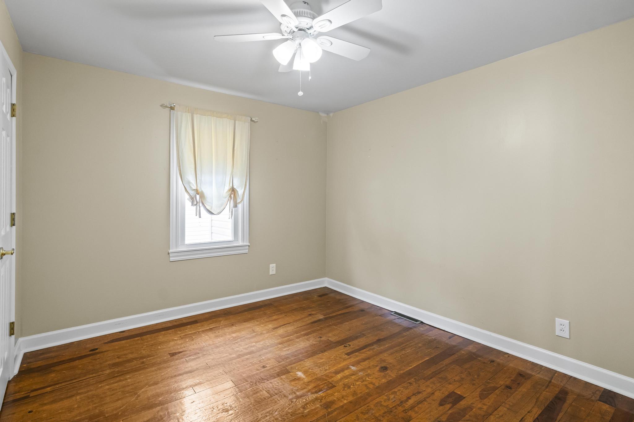 Bedroom featuring wood flooring and ceiling light fan