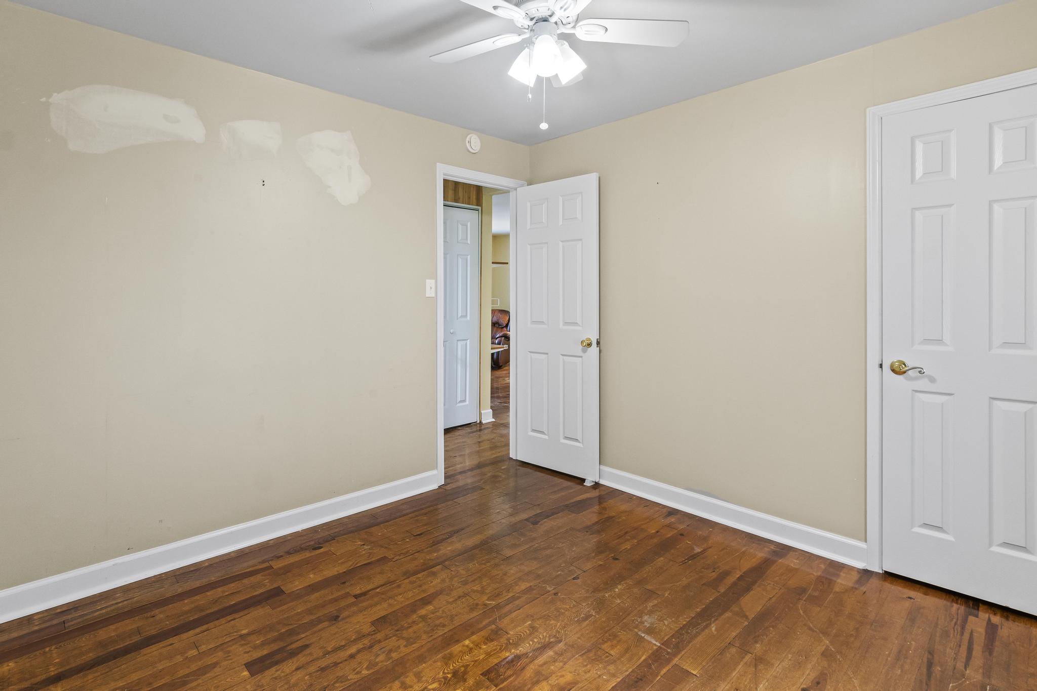 Bedroom featuring wood flooring and ceiling light fan