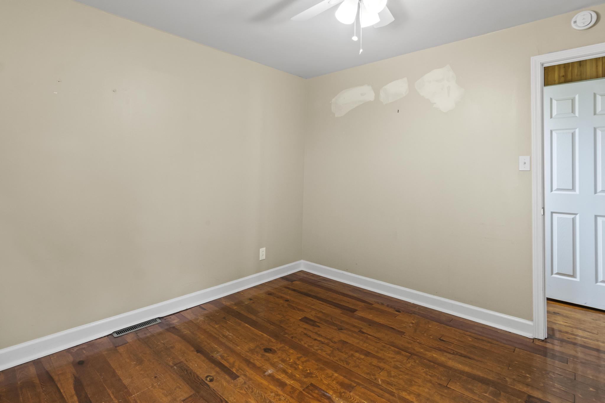 Bedroom featuring wood flooring and ceiling light fan