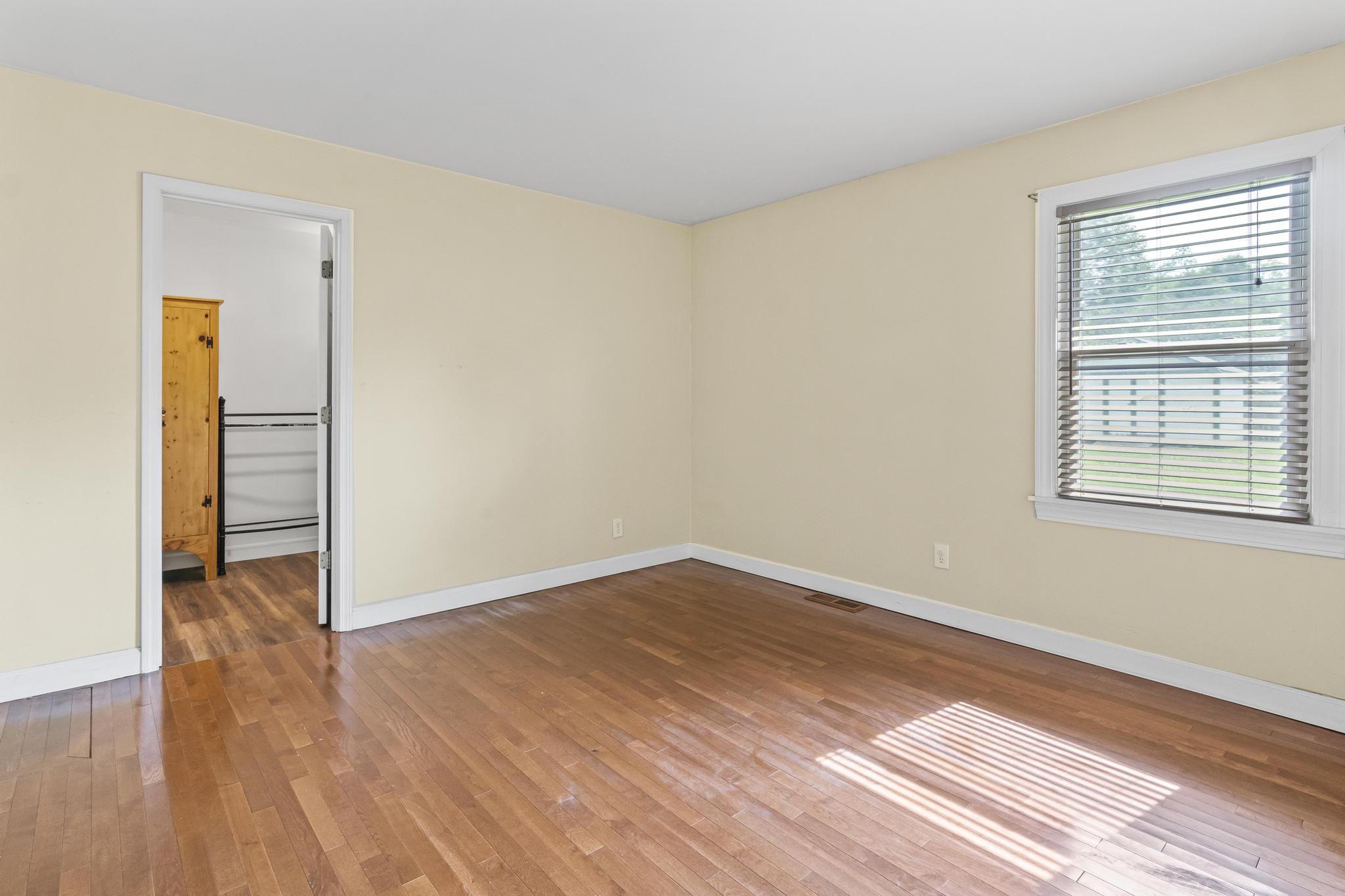 Master bedroom with wood flooring