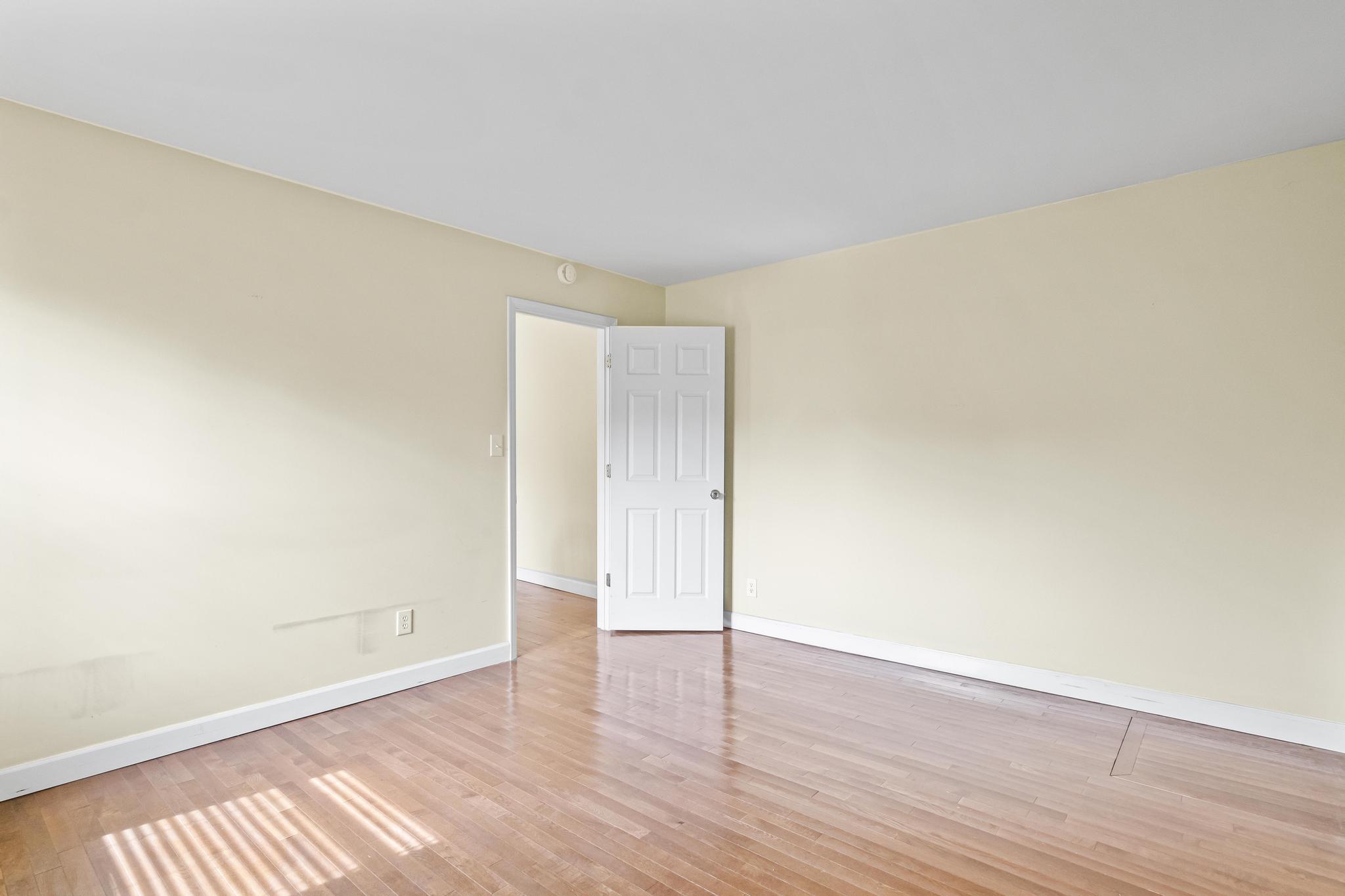 Master bedroom with wood flooring