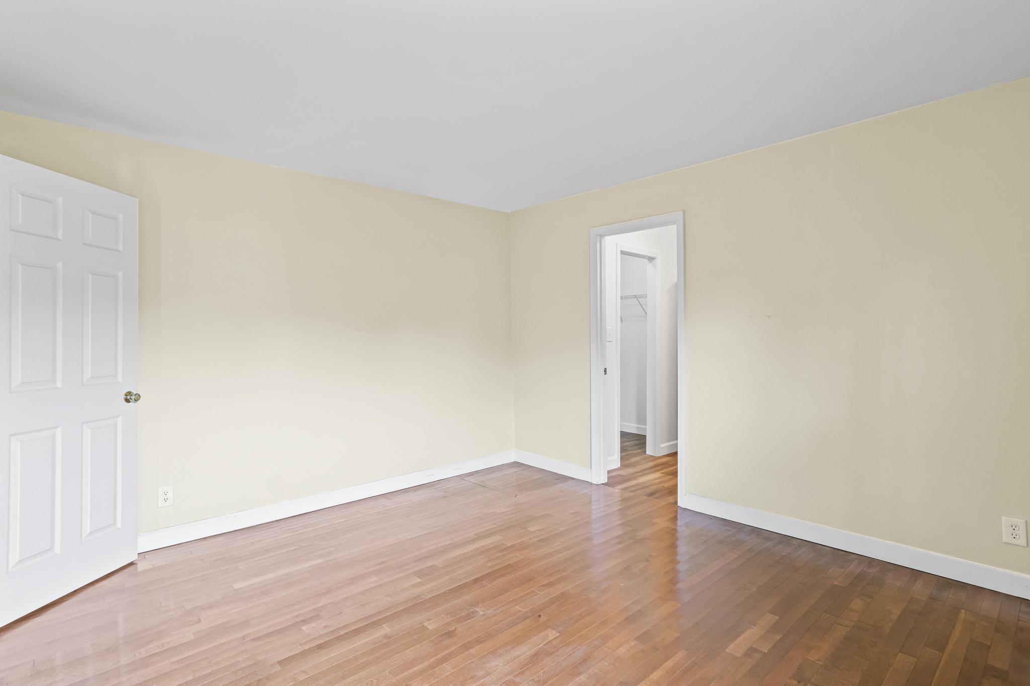 Master bedroom with wood flooring