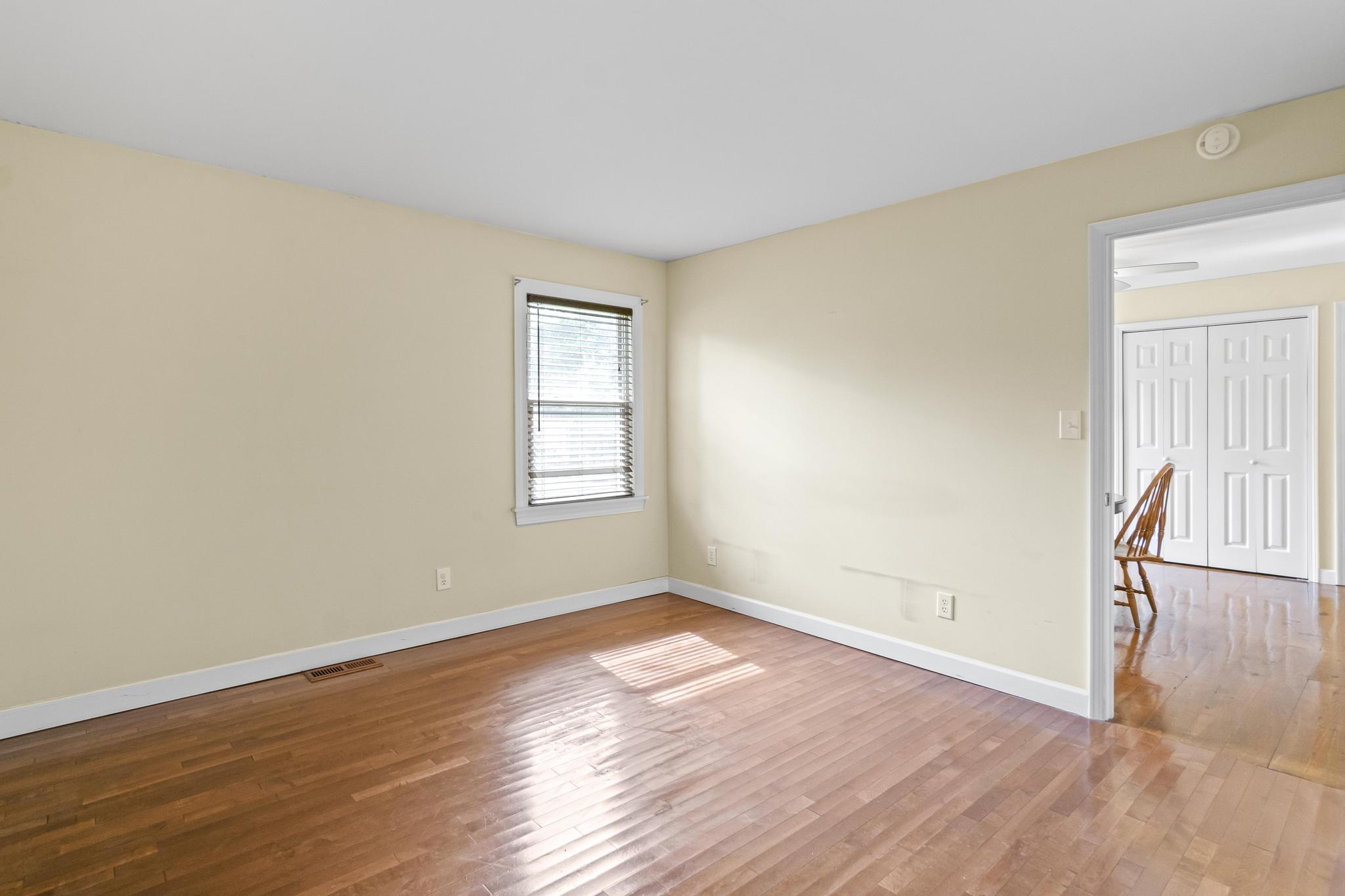 Master bedroom with wood flooring