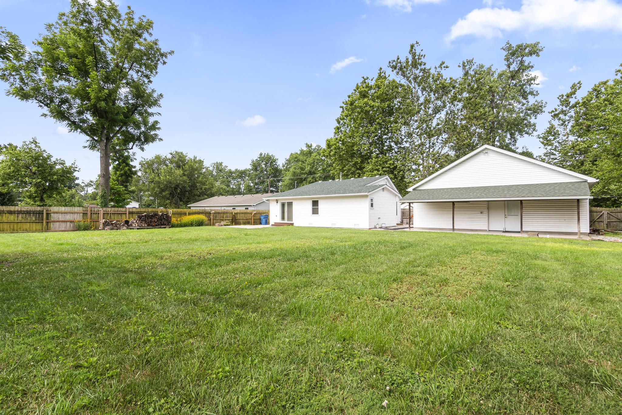 Exterior view of property with wood privacy fencing and landscaping