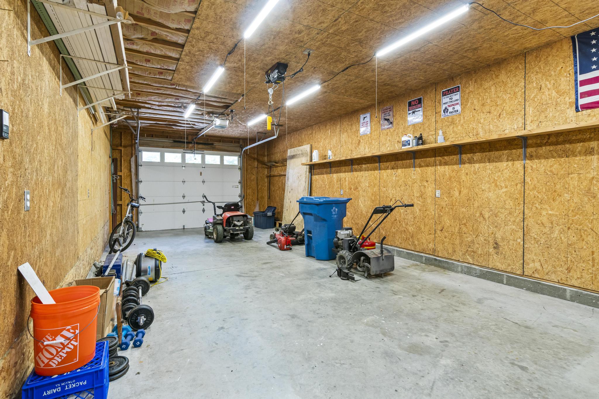 Garage interior view of left bay with overhead door opener