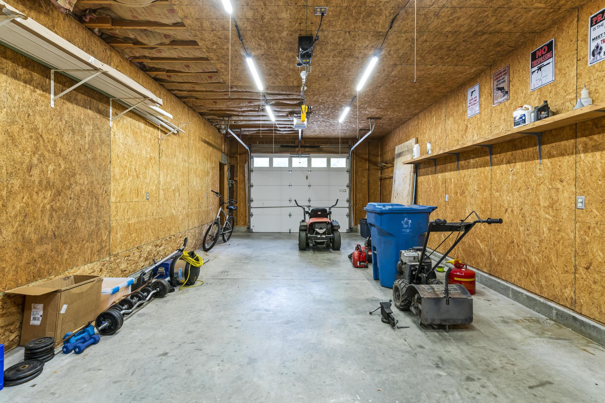 Garage interior view of left bay with overhead door opener