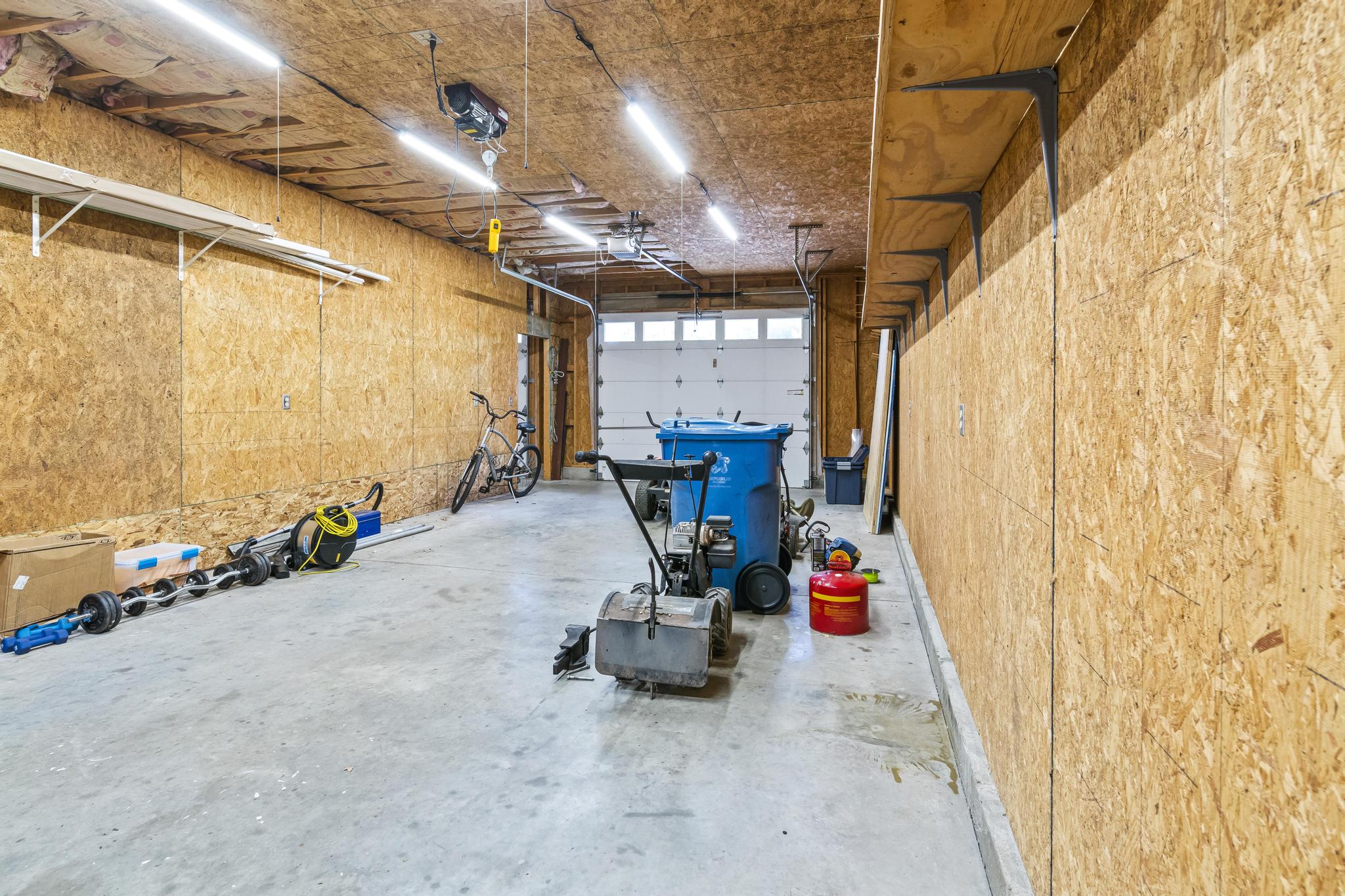 Garage interior view of left bay with overhead door opener