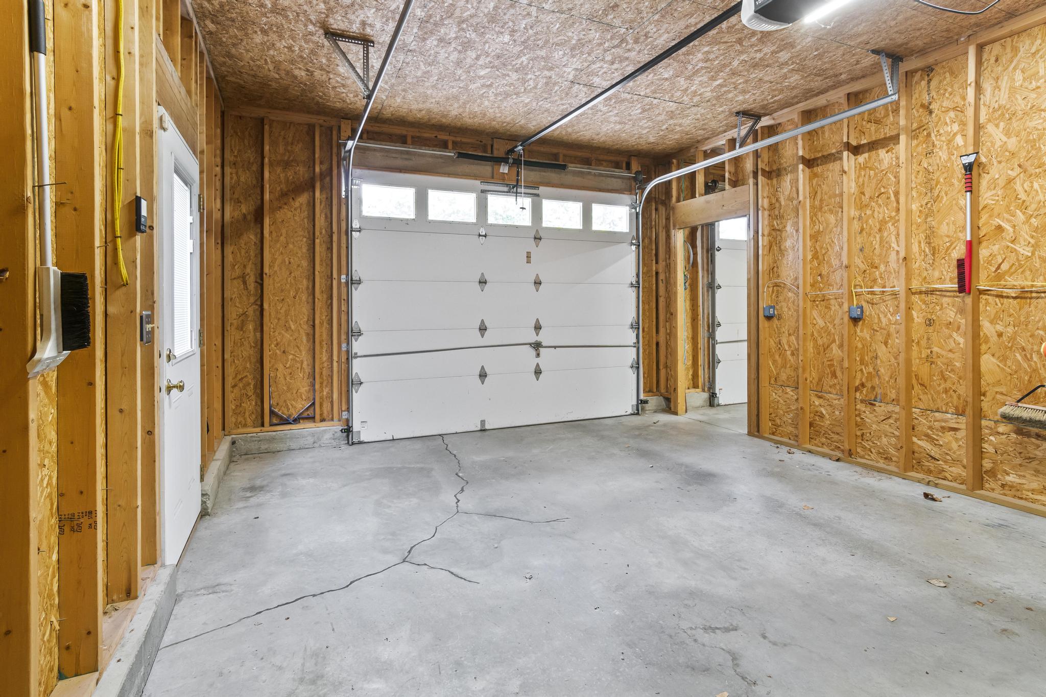 Garage interior view of right bay with overhead door opener