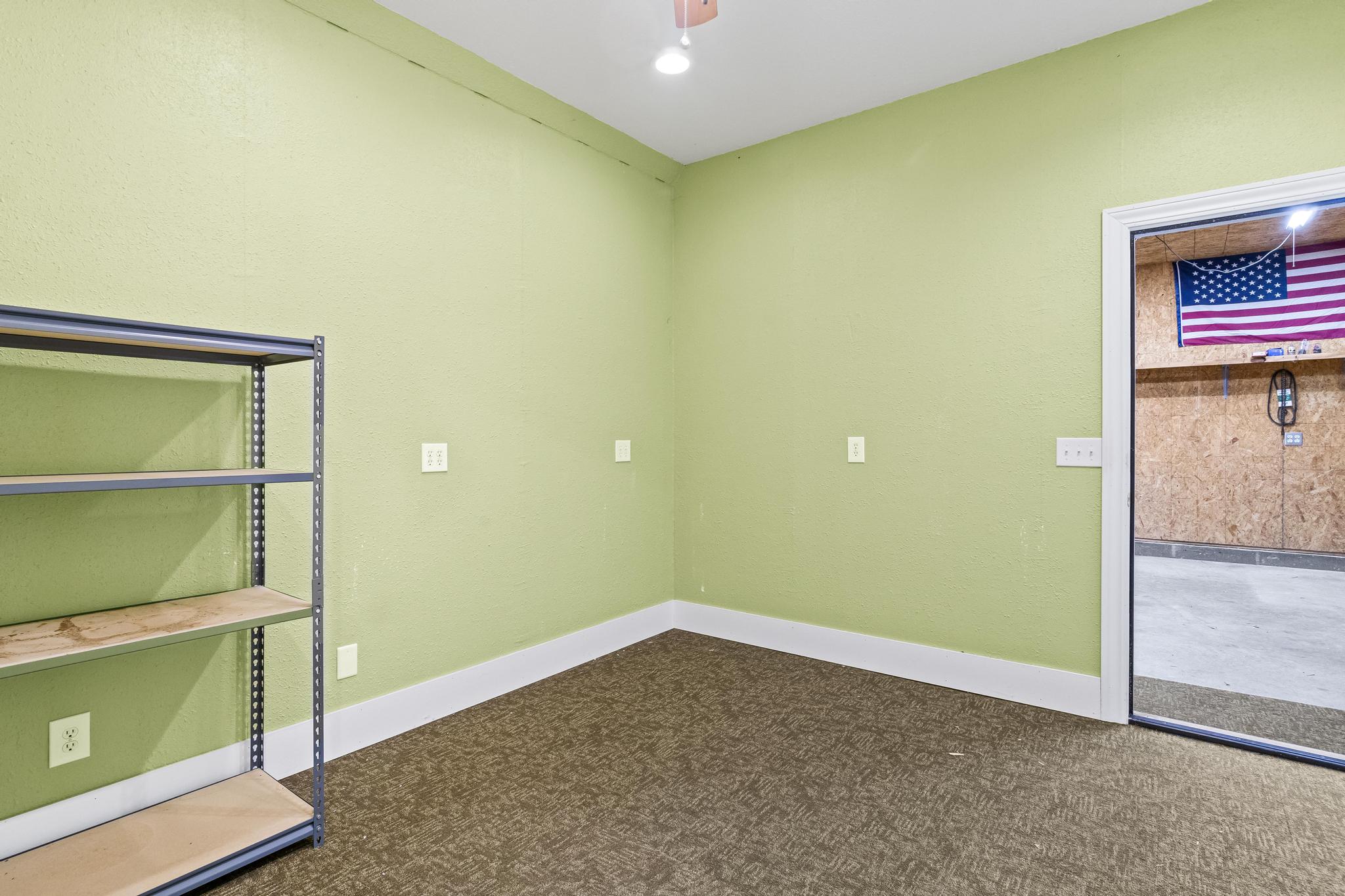 Garage office with carpeted flooring