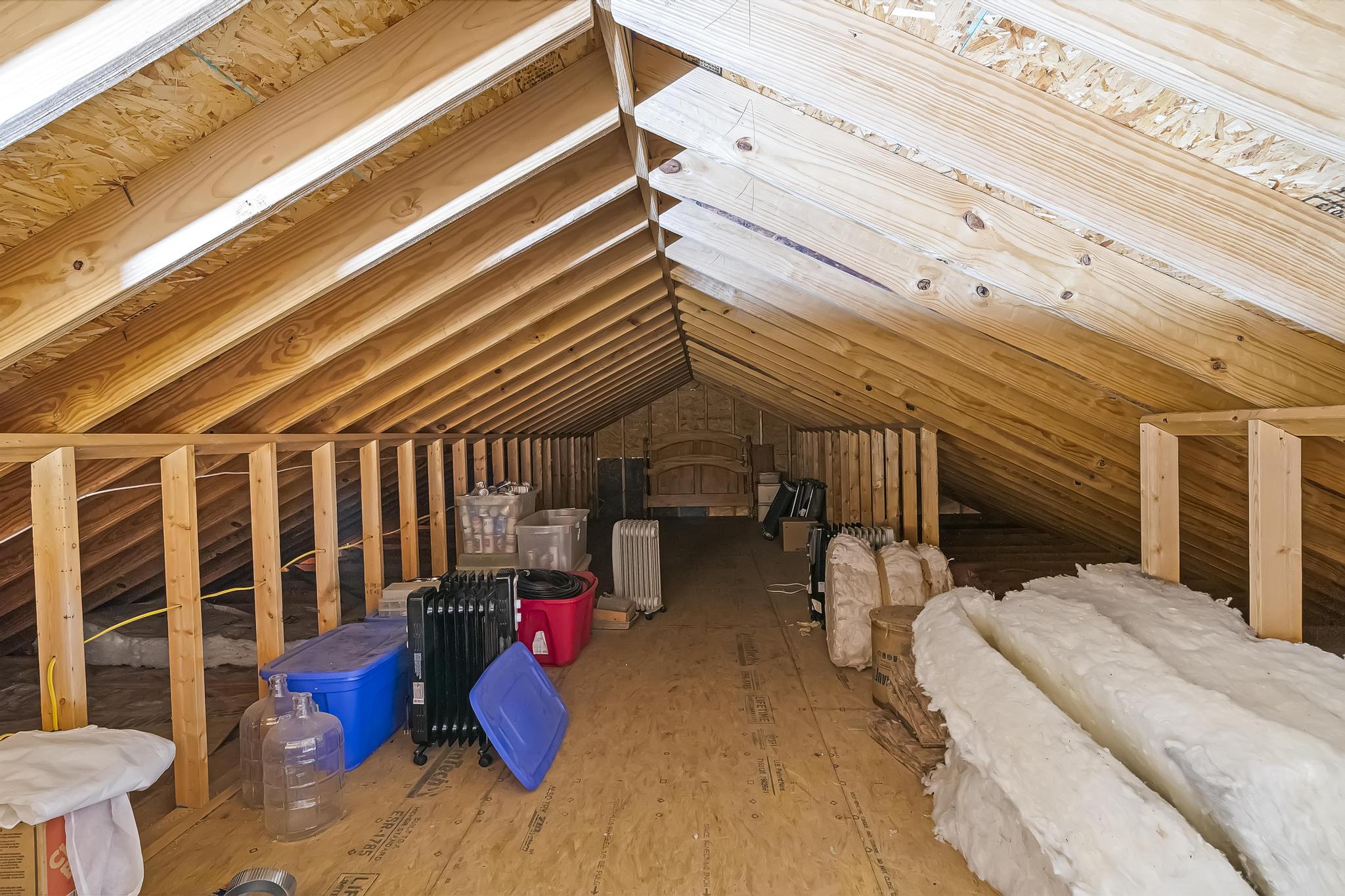 Interior view of garage attic featuring wood type flooring