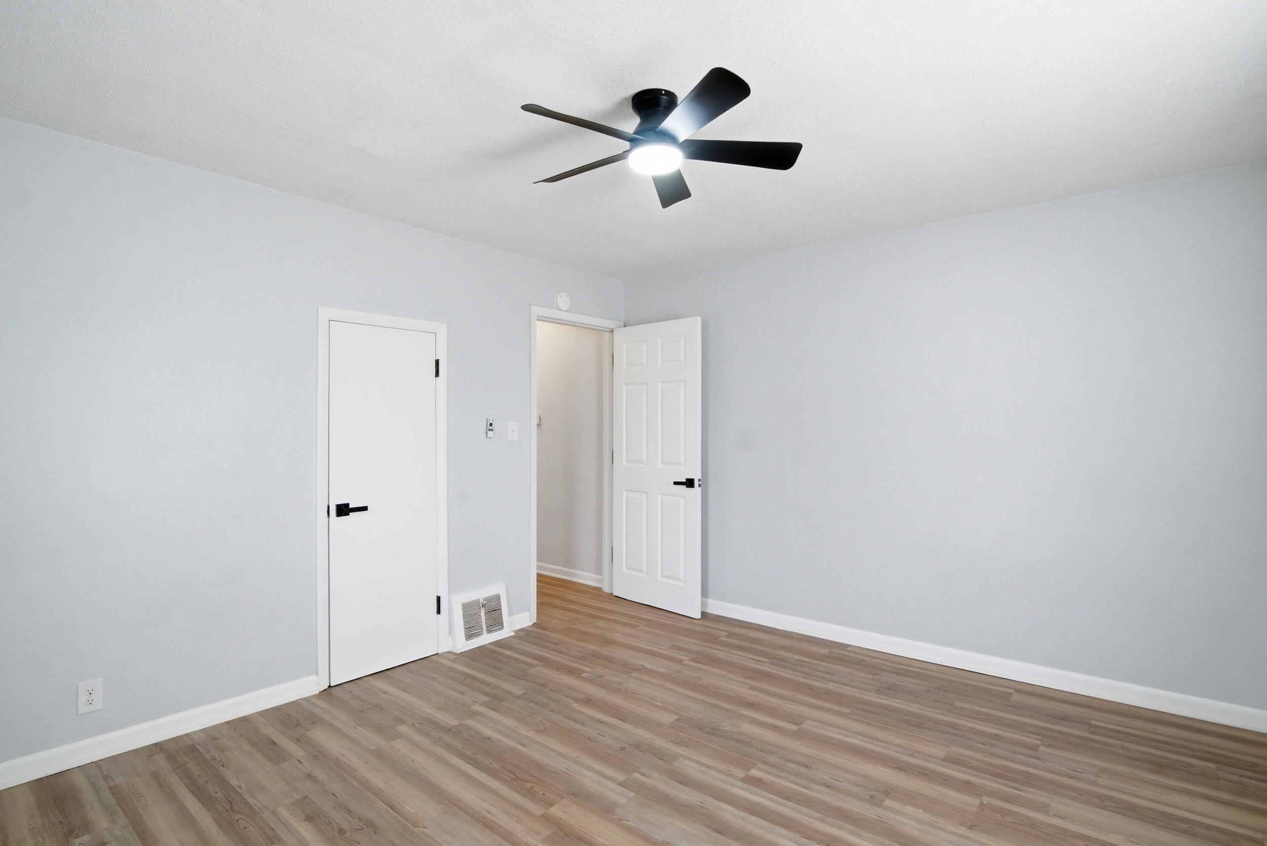 Single closet in front bedroom featuring neutral grey paint, wood-look flooring, at 1929 Beckwith St. Madison.
