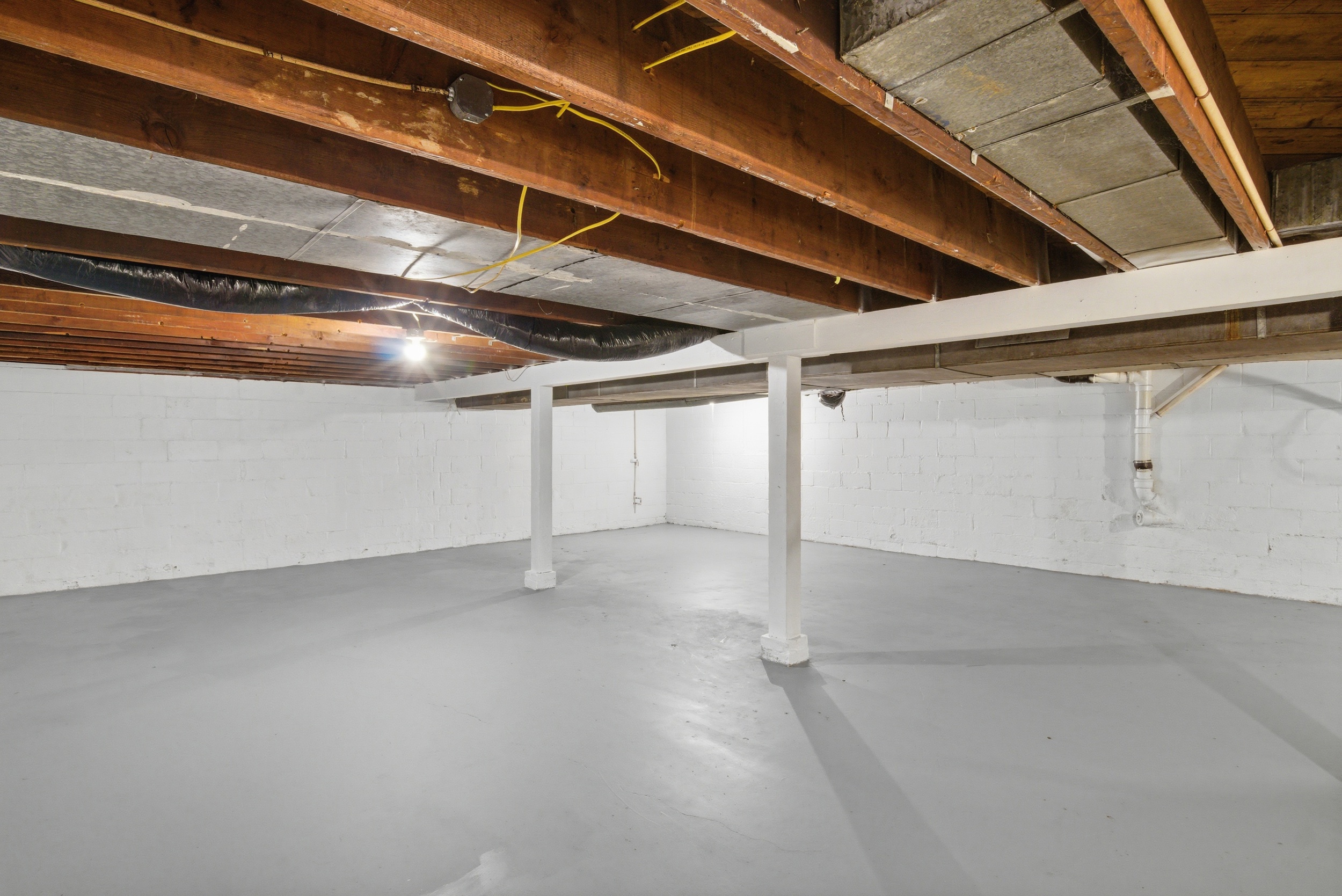 Full unfinished clean painted basement at 1929 Beckwith St. Madison.