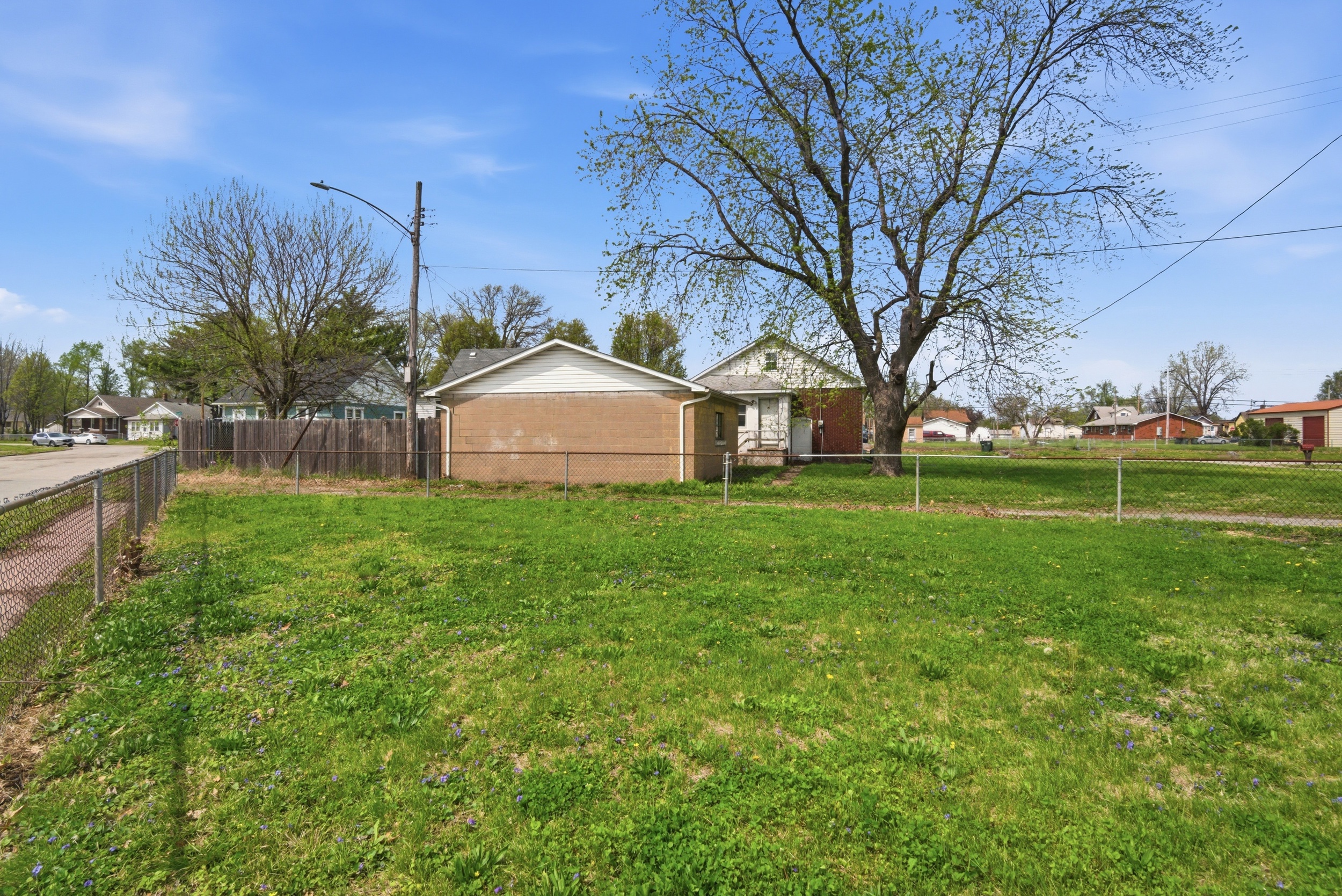 Fenced yard, concrete sidewalk and alley access at 1929 Beckwith St. Madison.