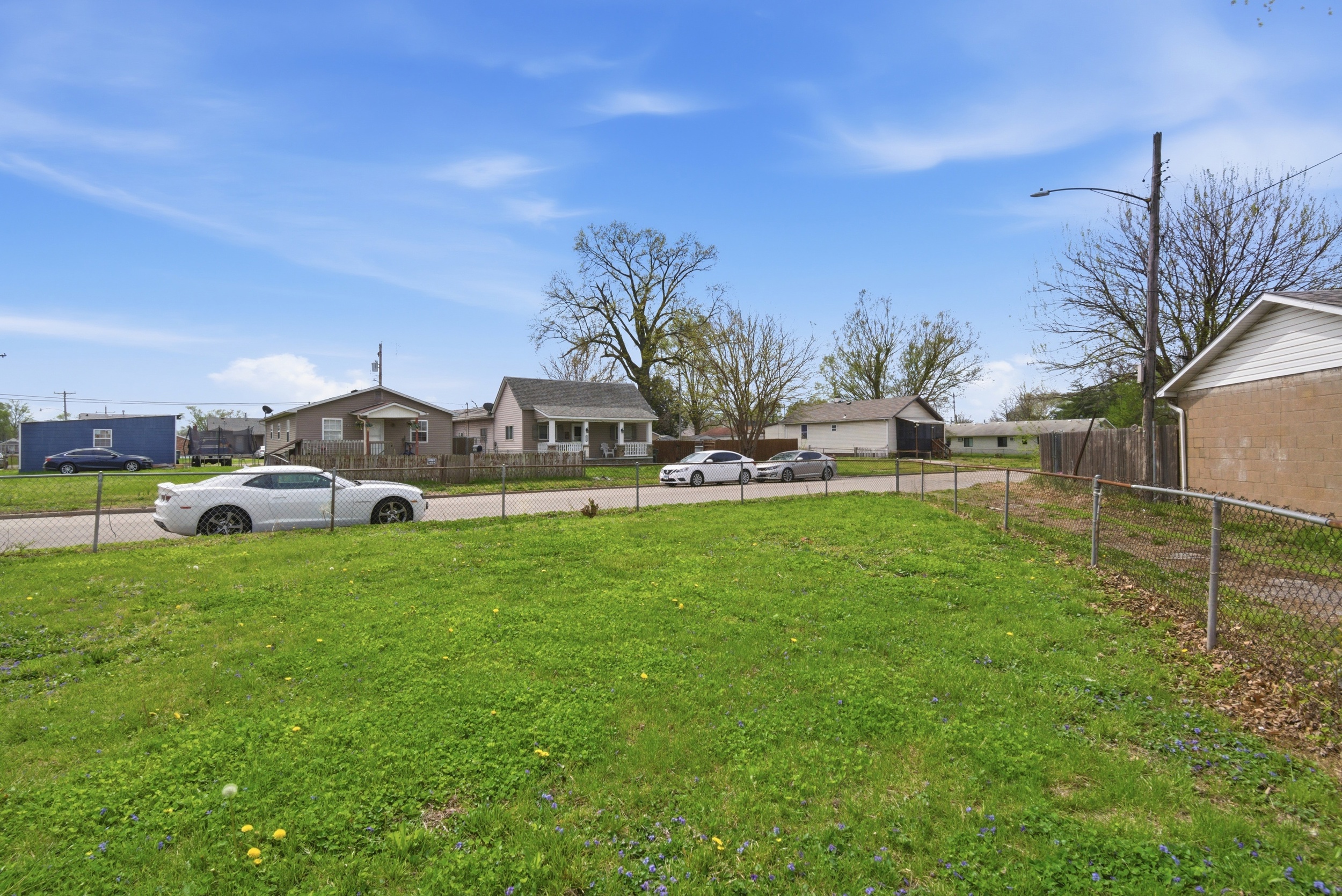 View of fenced in corner lot yard at 1929 Beckwith St. Madison.